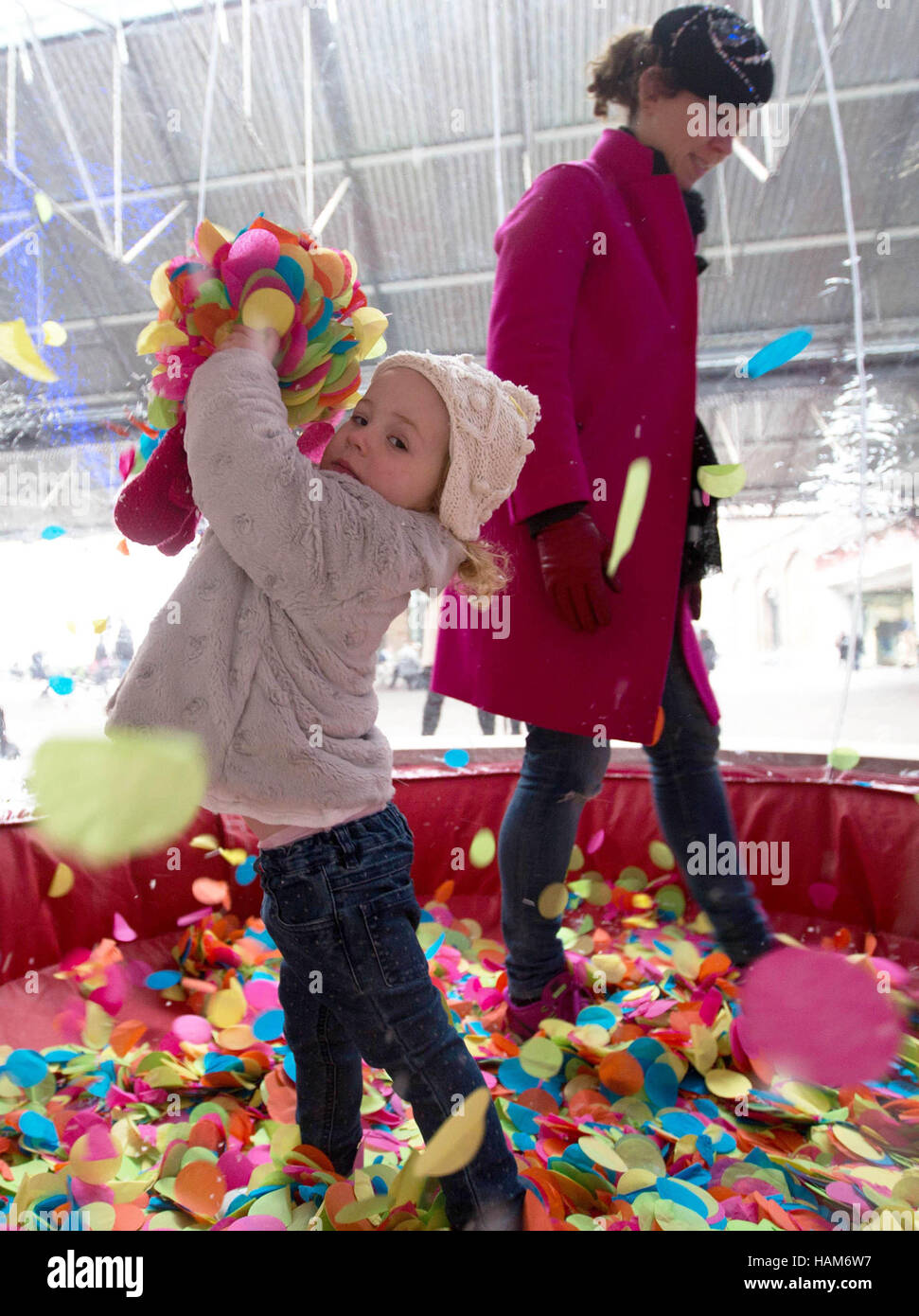 EDITORIAL USE ONLY Siobhan Fitzgerald and her daughter Aoife Cunnington play at an attraction unveiled by online shopping hub Notonthehighstreet.com in celebration of 'Colour Saturday', at King's Cross in London. Stock Photo
