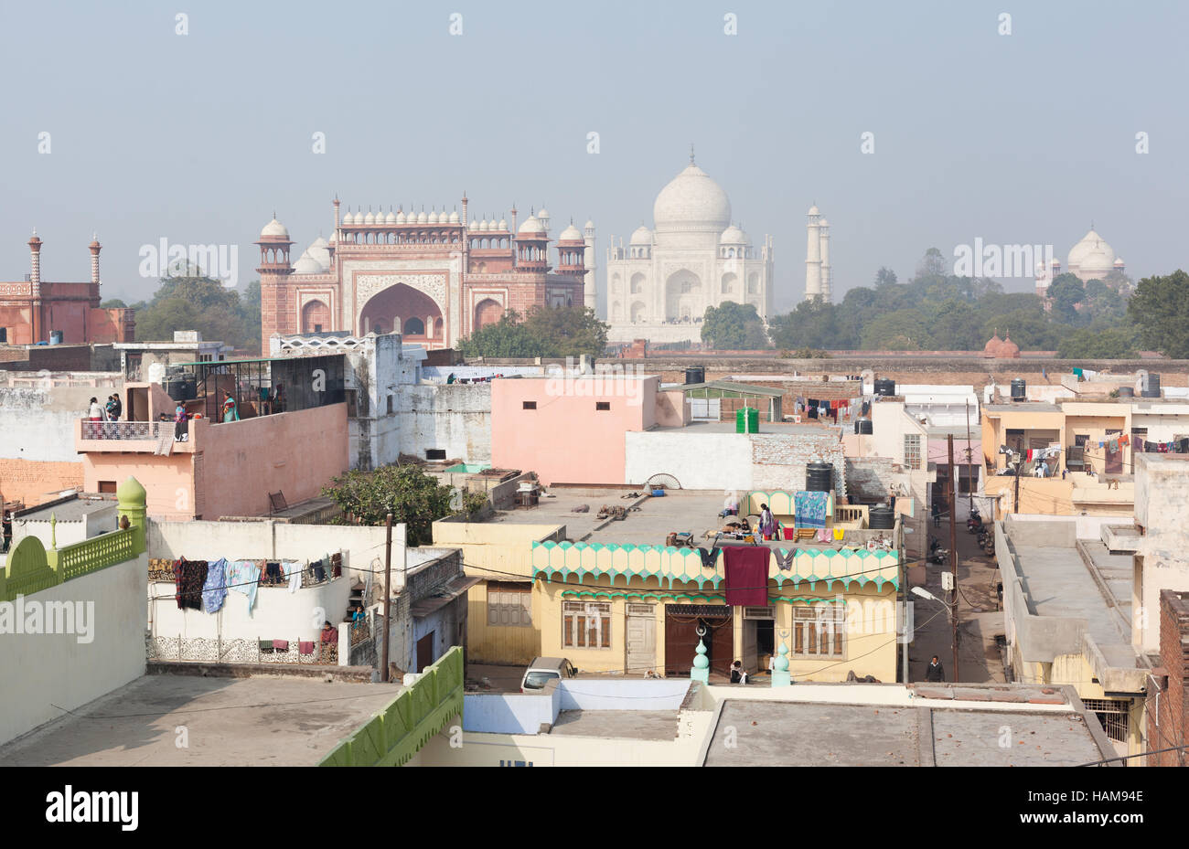 AGRA, INDIA - JANUARY 1, 2015 : Skyline view across residential rooftops towards the Taj Mahal on a hazy day. Stock Photo