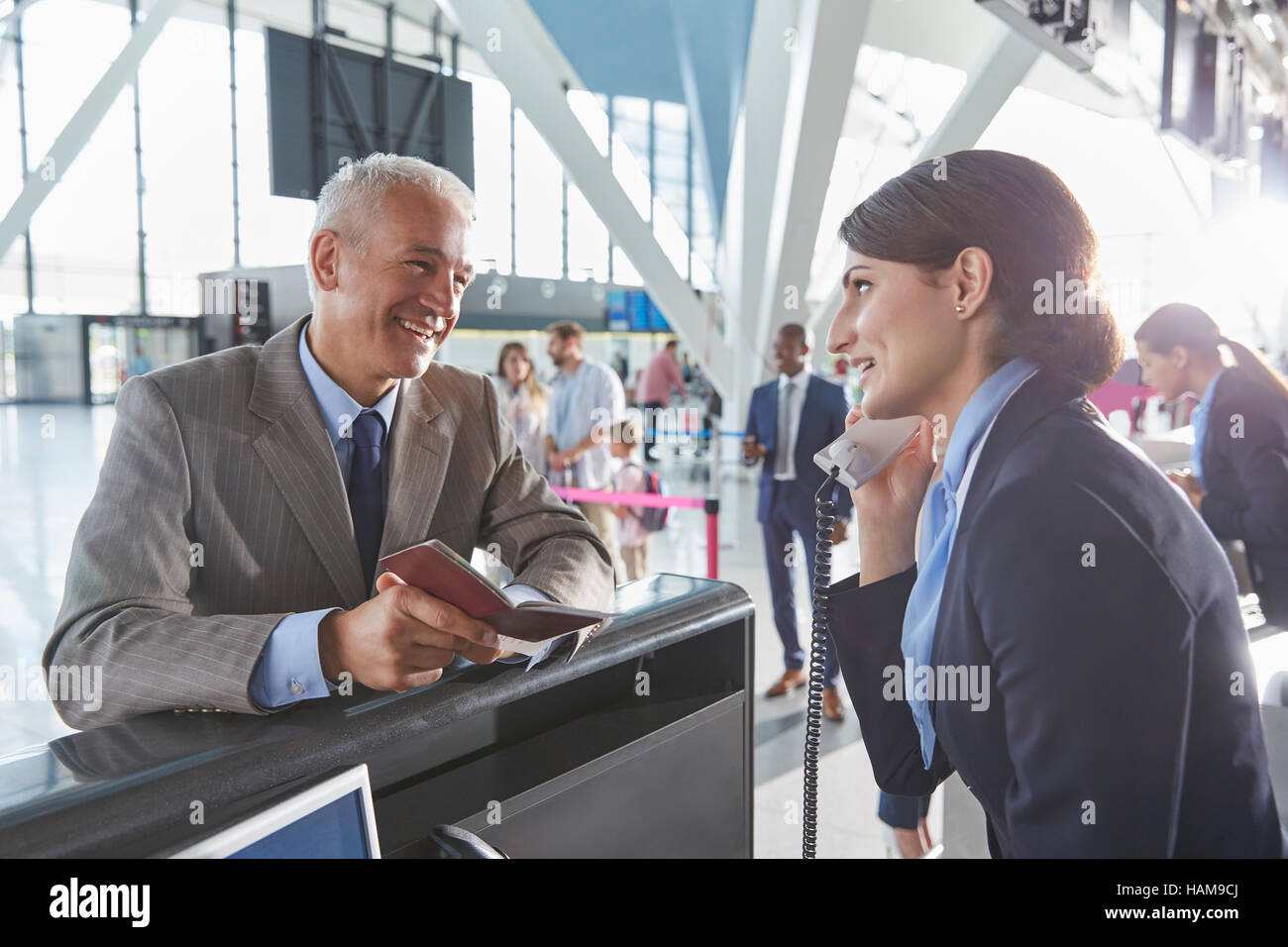 Customer service representative helping businessman with passport at