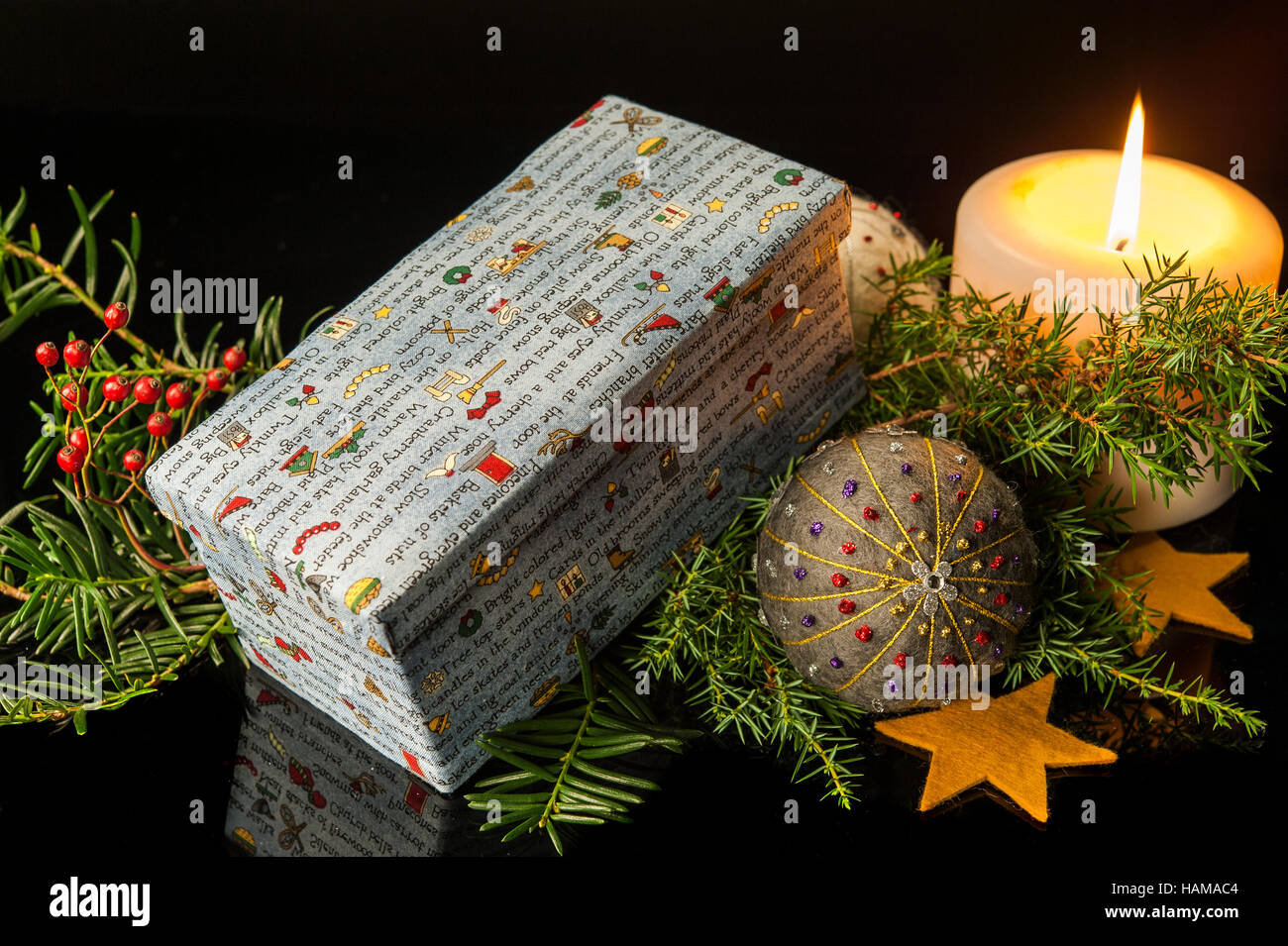 Christmas decoration, box with colourful Christmas theme, lit candle, hand felted and embroidered bauble Stock Photo