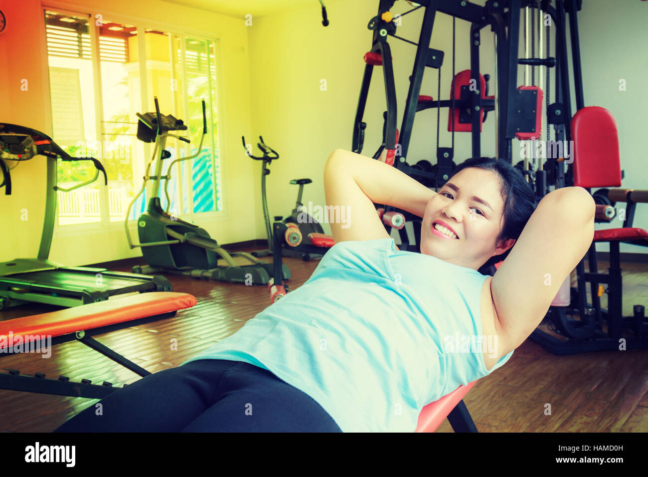 Asia fat woman sit up in the gym for strength, weight loss. Stock Photo