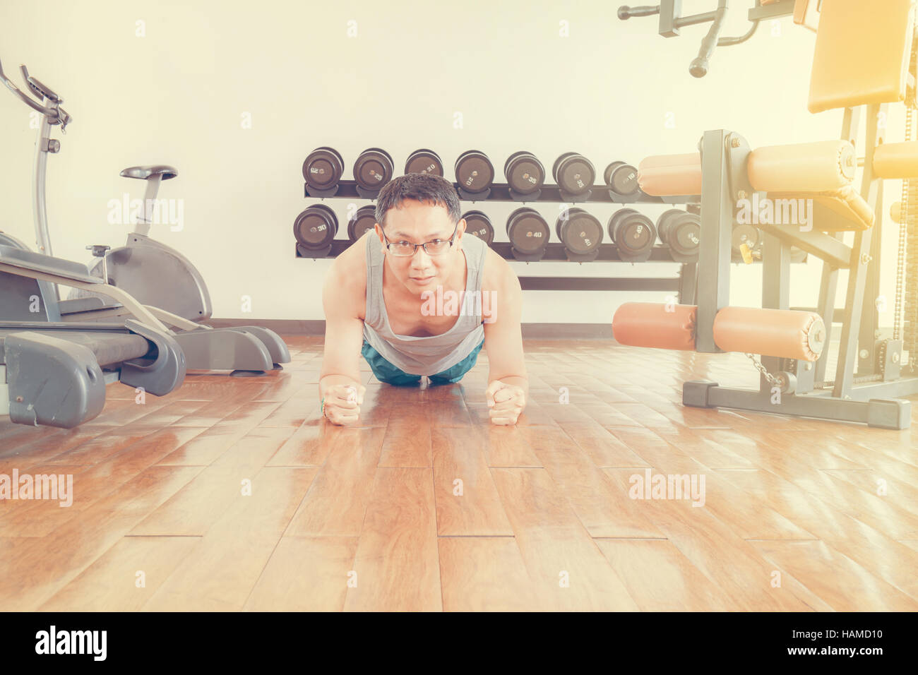 Asia man middle aged push up in the gym for strength, weight loss. Stock Photo