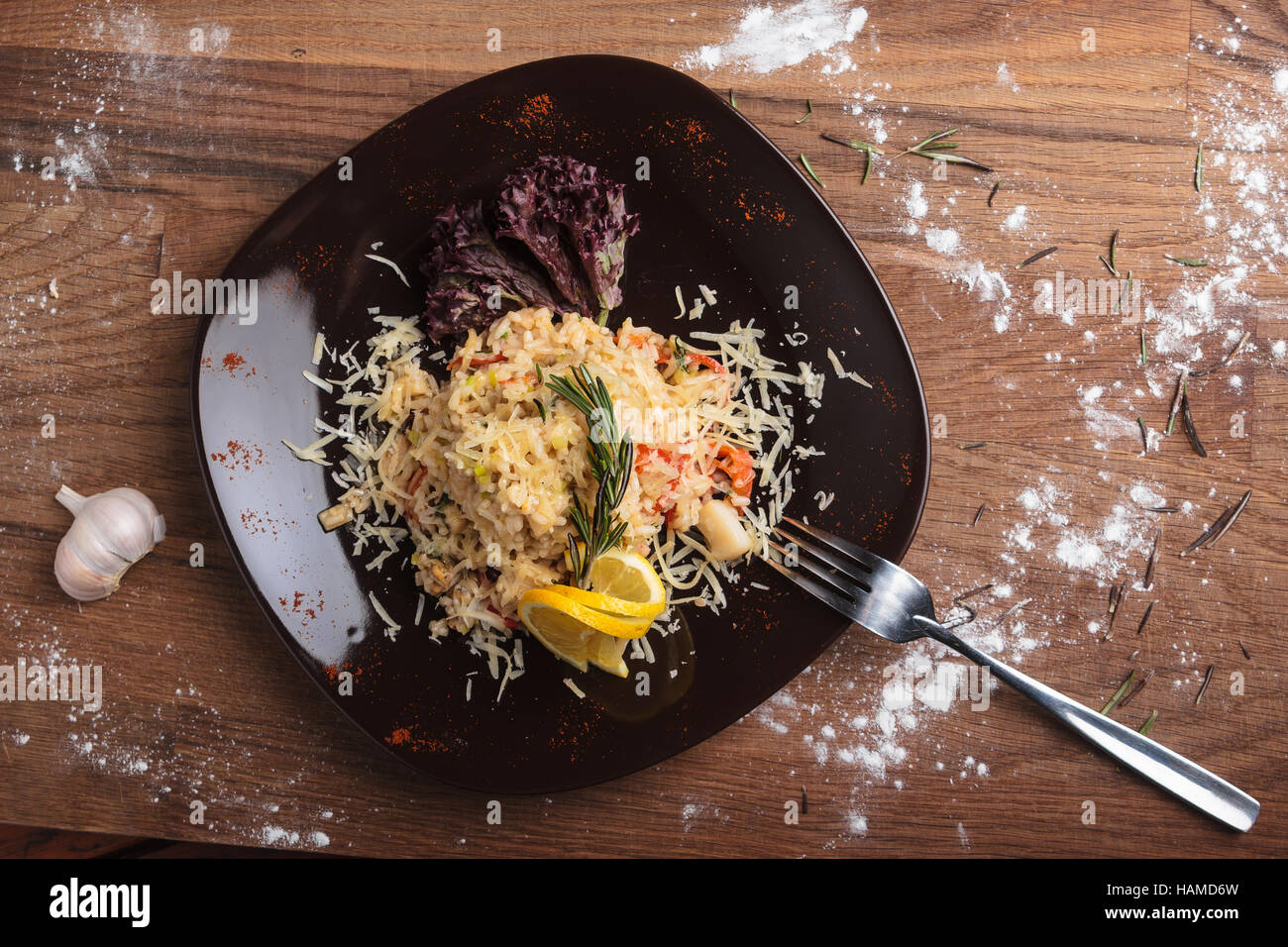 Concept: restaurant menus, healthy eating, homemade, gourmands, gluttony. Risotto with seafood on a weathered wooden background. Top-down view. Stock Photo