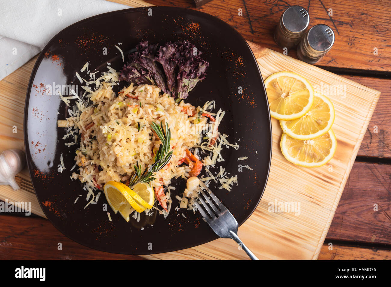 Concept: restaurant menus, healthy eating, homemade, gourmands, gluttony. Risotto with seafood on a weathered wooden background. Top-down view. Stock Photo