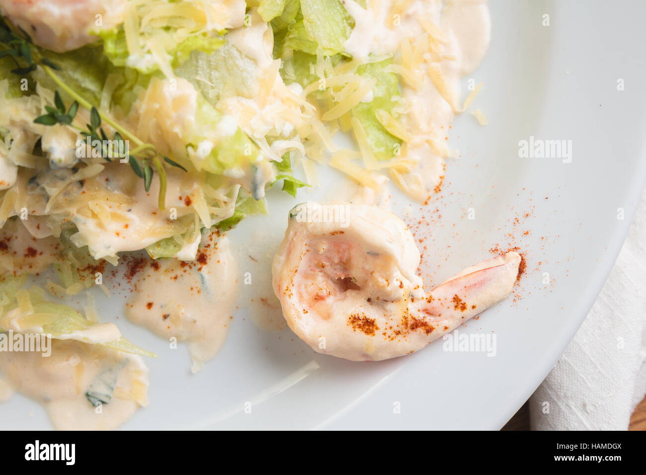 Concept: restaurant menus, healthy eating, homemade, gourmands, gluttony. White plate of salad with tiger prawns, flambeed in cognac, parmesan and cre Stock Photo