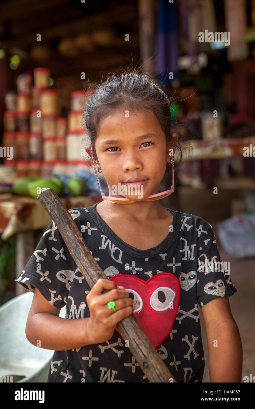 Portrait of a ten-year old Cambodian Khmer girl working at her mother's roadside tourist stand near Siem Reap, Cambodia. Stock Photo