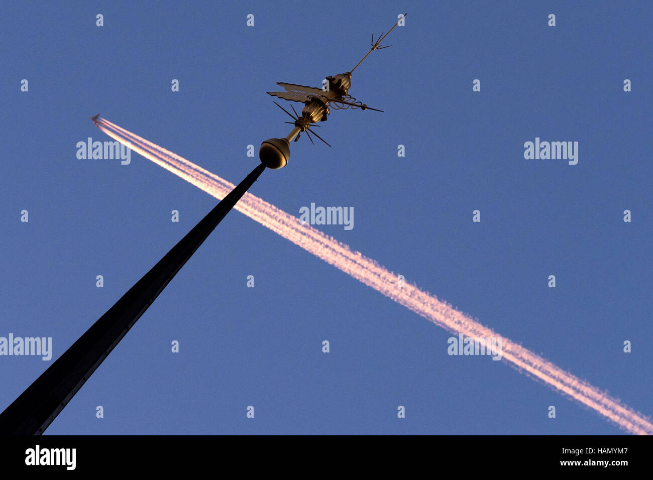 Dresden, Germany. 2nd Dec, 2016. A four turbine powered airplane flies along the blue sky past the tip of the Hausmann tower in Dresden, Germany, 2 December 2016. Photo: Arno Burgi/dpa-Zentralbild/dpa/Alamy Live News Stock Photo
