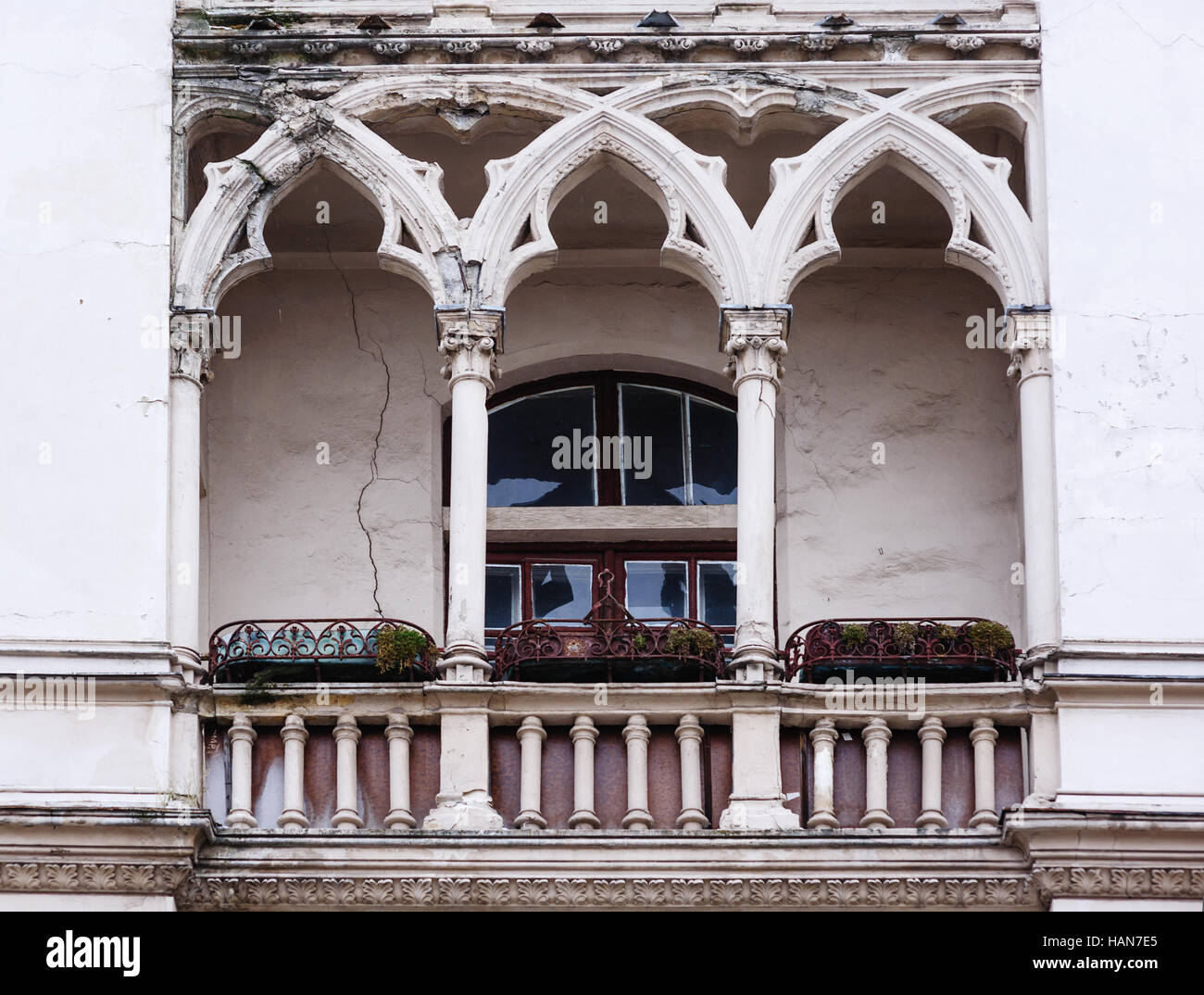 Antique balcony in the Gothic style on a building facade Stock Photo
