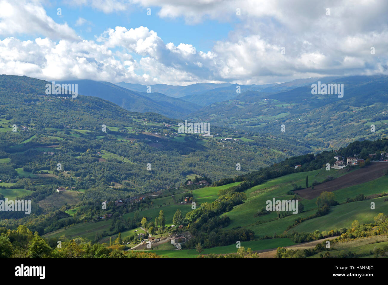 Rural landscape panorama with a meadow , hills on the horizon and  curved path Stock Photo