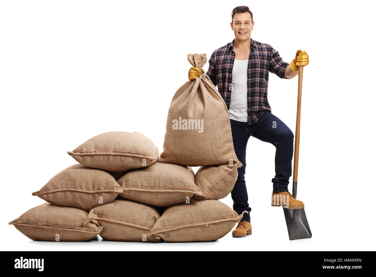 Full length portrait of a male farmer with a shovel under his foot ...