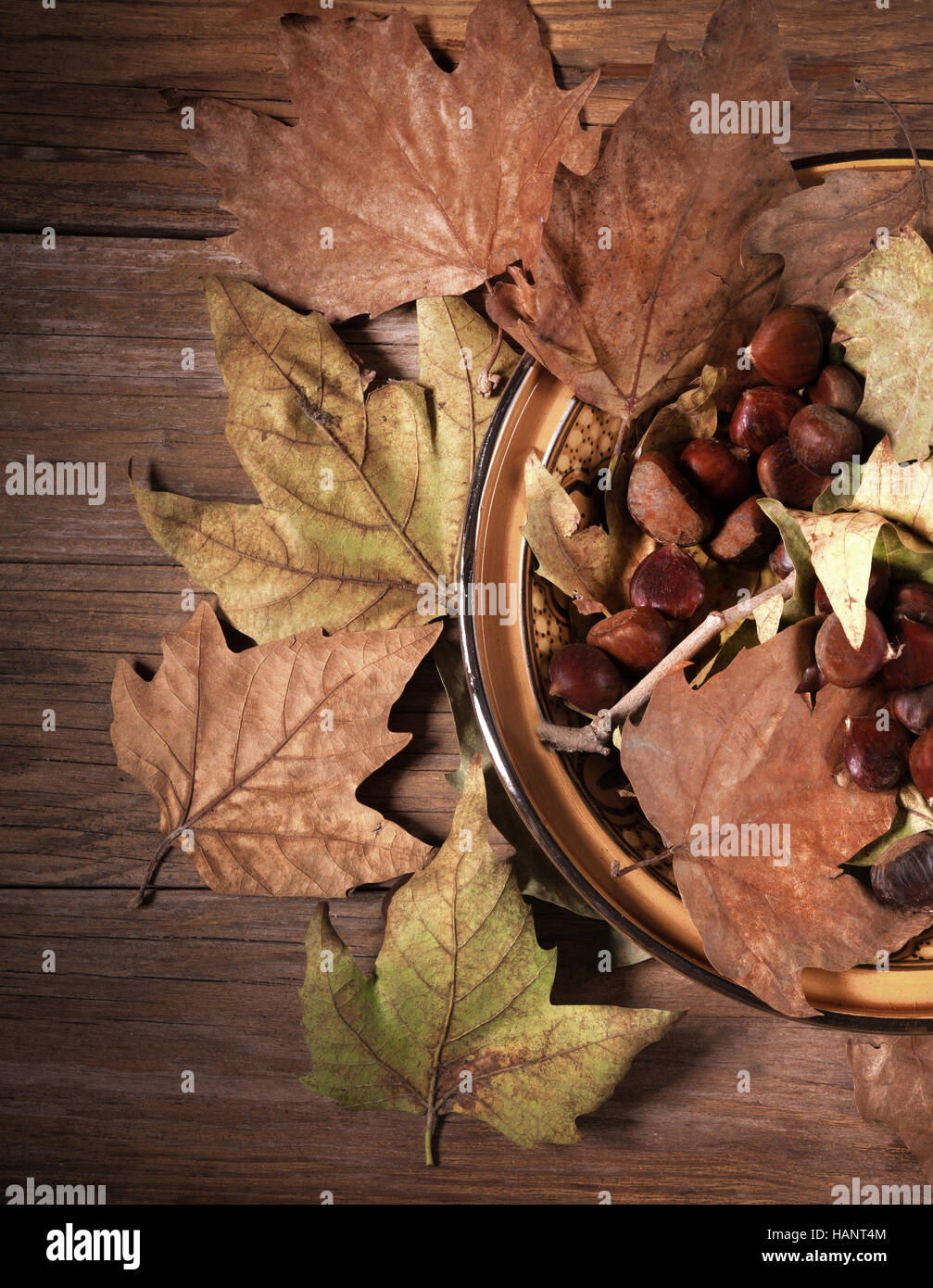 frame of dry leaves and chestnuts on old wooden table Stock Photo - Alamy