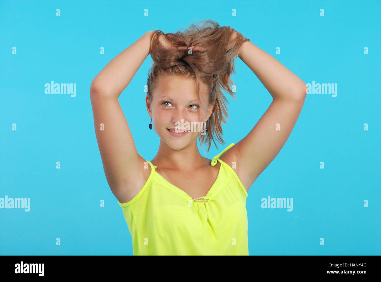 Beautiful happy smiling teen girl over blue background Stock Photo - Alamy