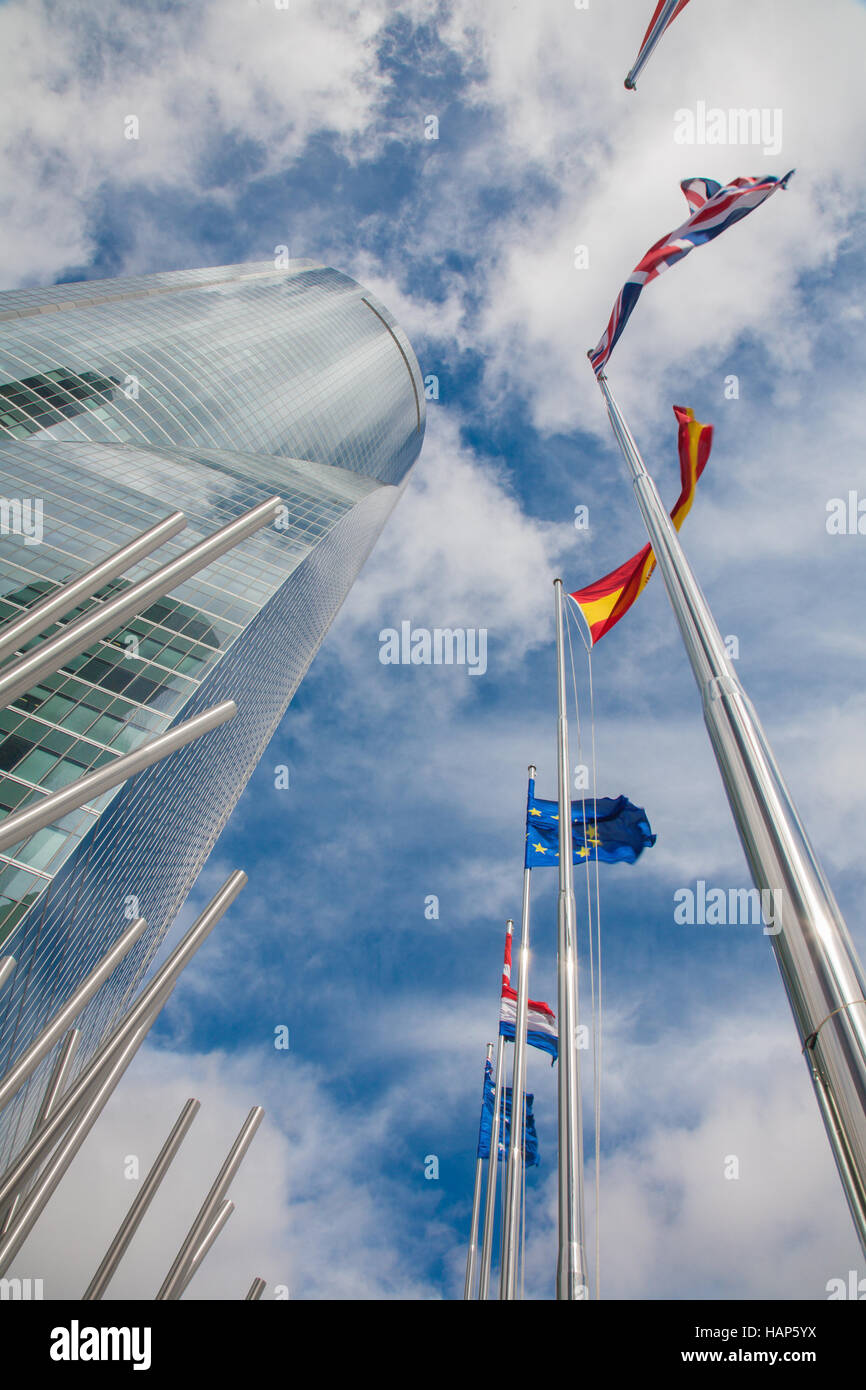 MADRID, SPAIN - MARCH 11, 2013: Skyscraper Torre Espacio and flags. Building was constructed in 2007 and designed by architect Henry N. Cobb. Stock Photo