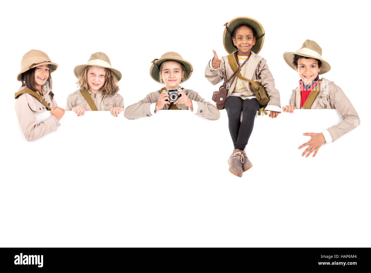 Children's group with safari clothes and gear over a white board Stock ...
