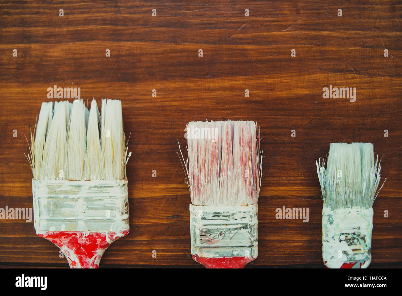 Three painting brushes on boards Stock Photo Alamy