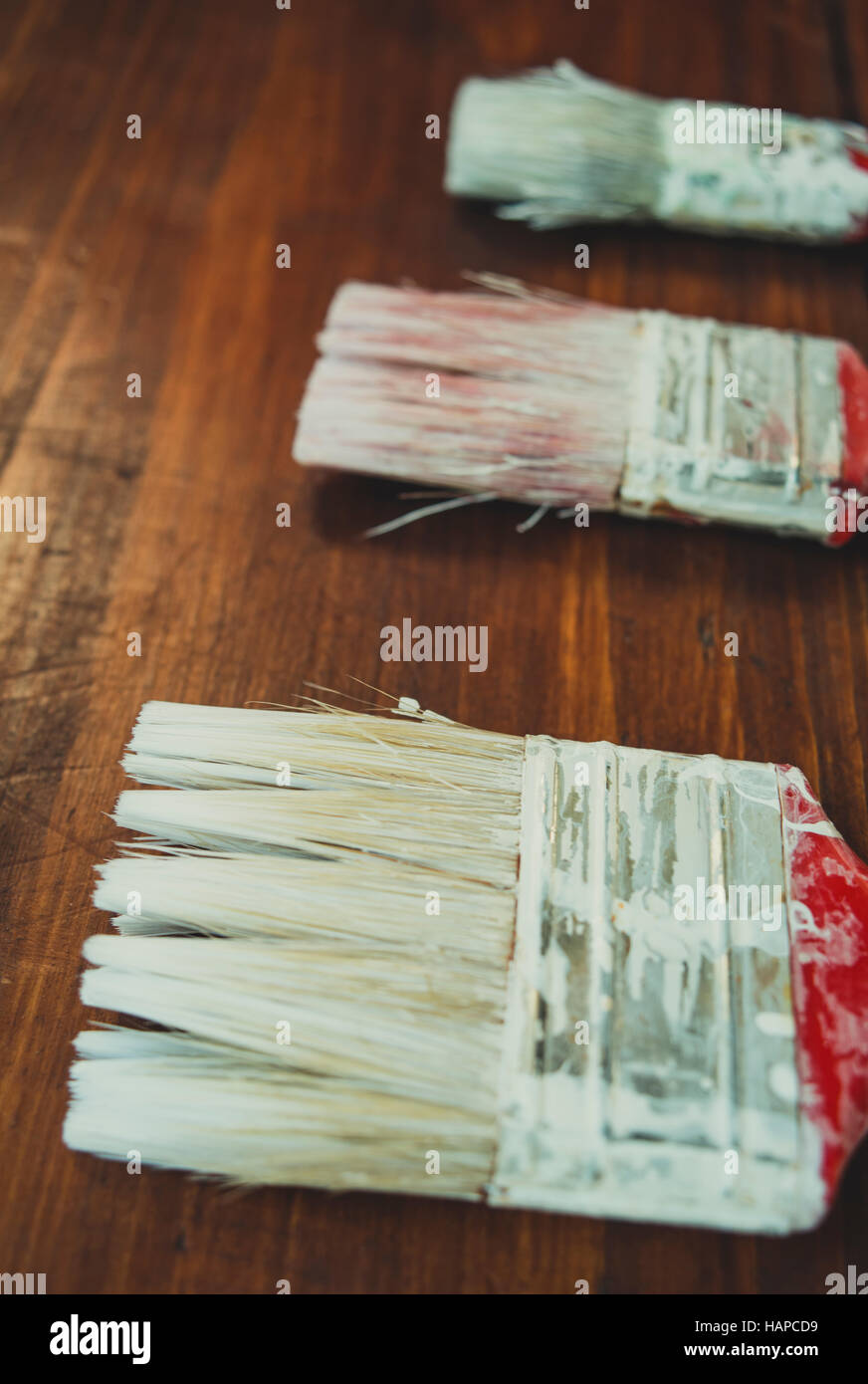 Three painting brushes on boards Stock Photo Alamy