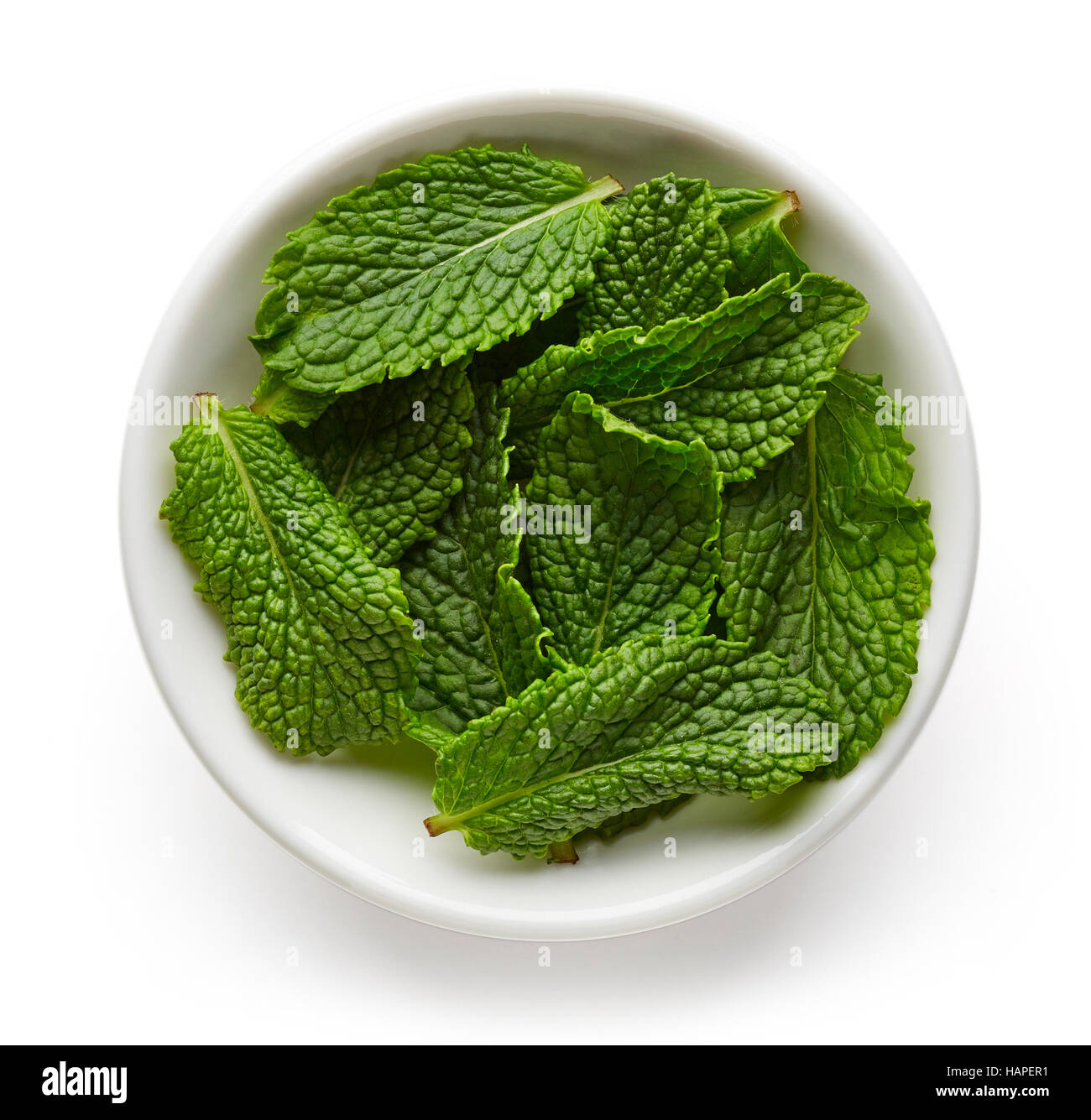 Bowl of mint leaves isolated on white background, top view Stock Photo