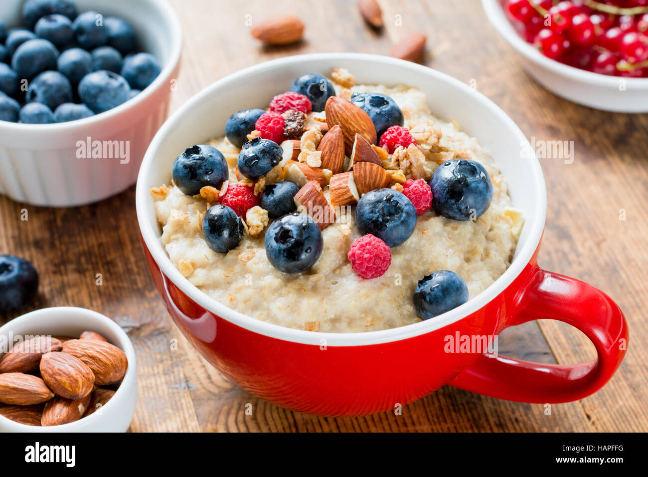 Oatmeal porridge with fruits and nuts for healthy breakfast Stock Photo