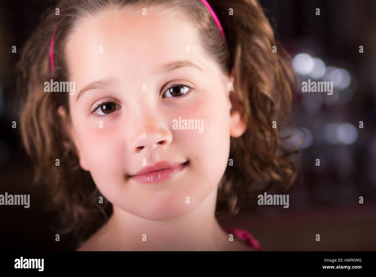 Beautiful young girl looking peacefully at the camera Stock Photo - Alamy