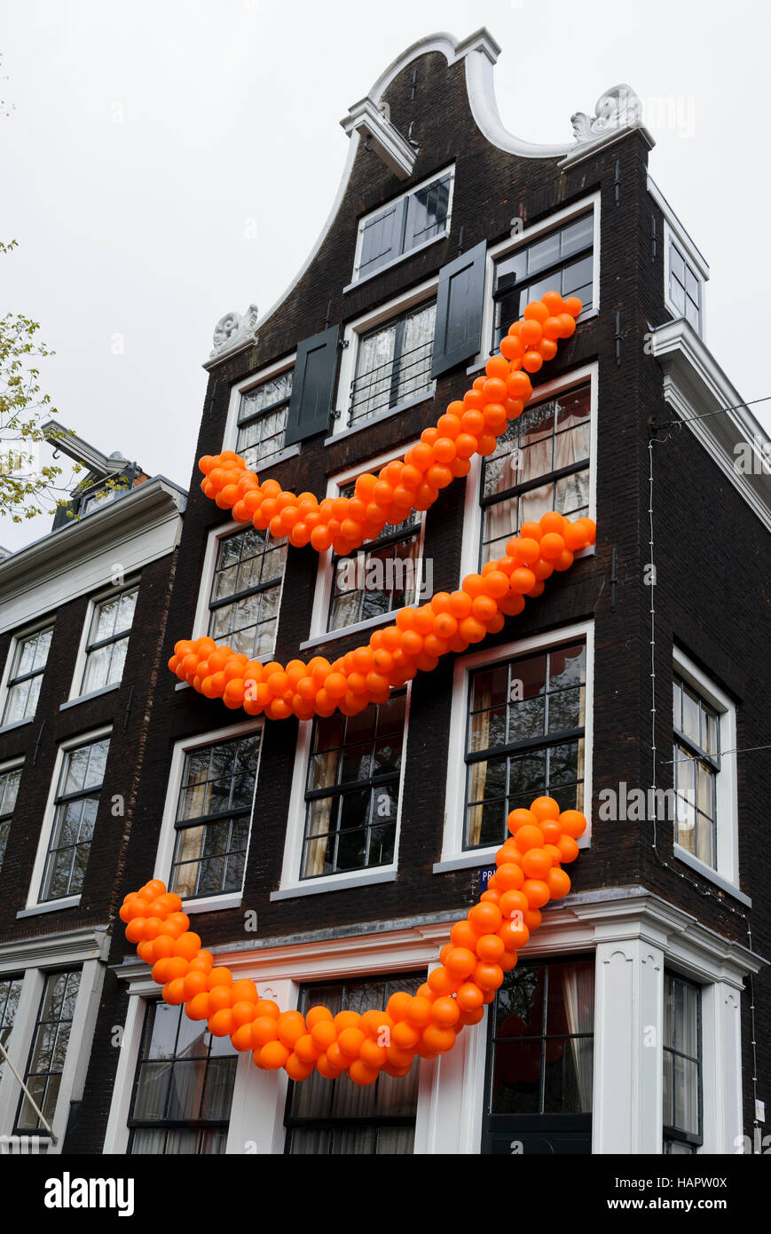 A building decorated with orange coloured balloons during the King's