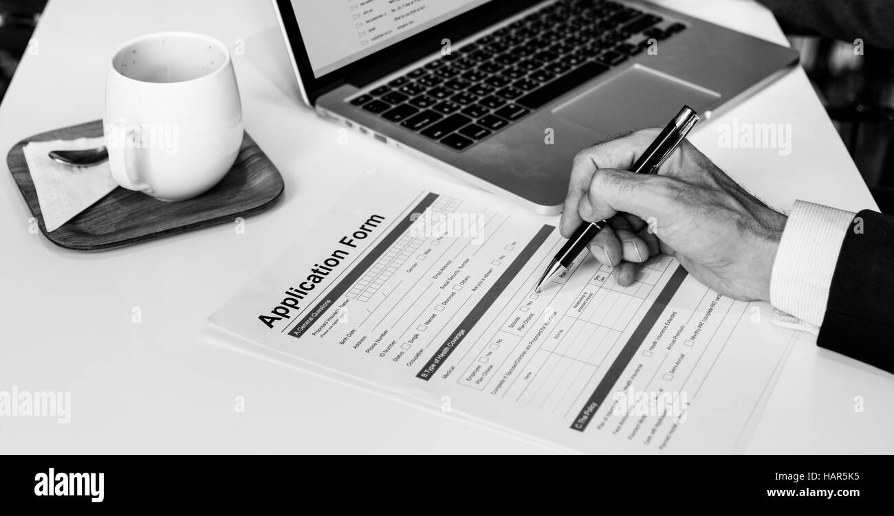 Businessman filling out form desk Black and White Stock Photos & Images ...