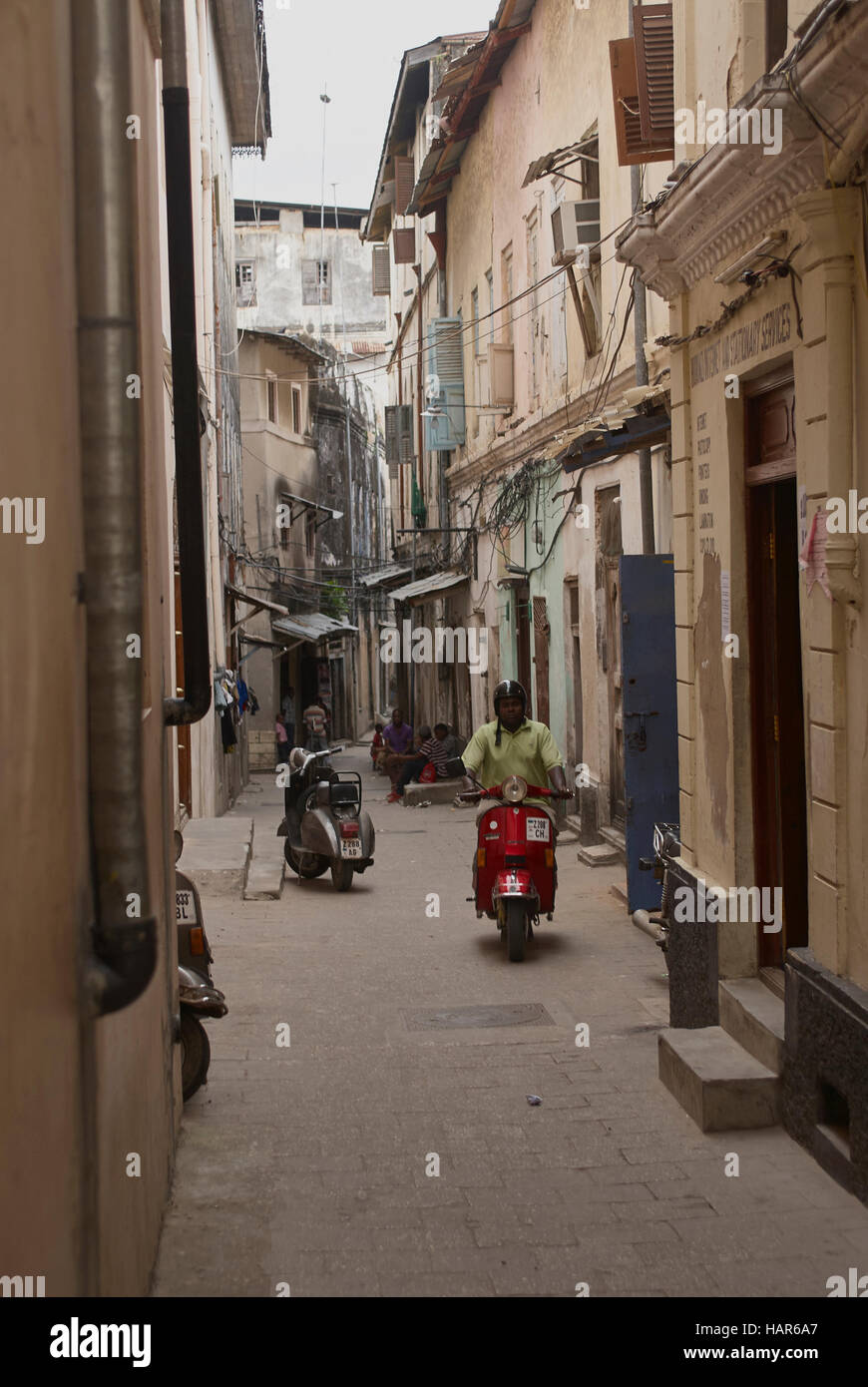 Typical street life in the narrow streets of ancient stone town Zanzibar, Tanzania Stock Photo