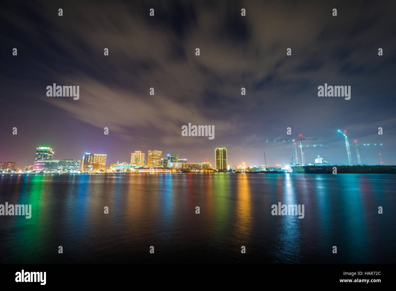 The skyline of Norfolk at night, seen from the waterfront in Portsmouth, Virginia. Stock Photo