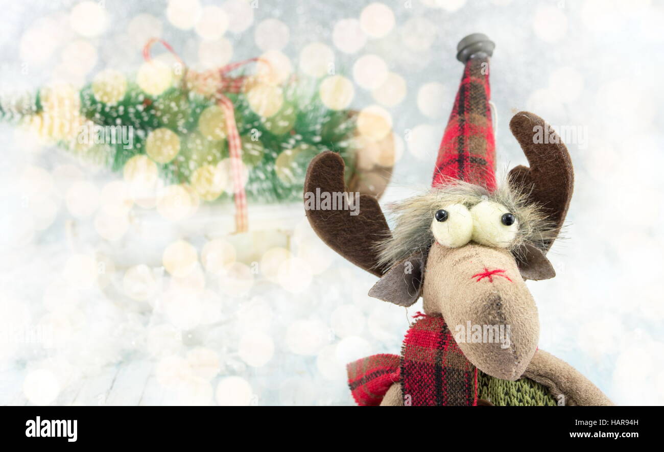 Funny reindeer toy and Christmas lights background Stock Photo