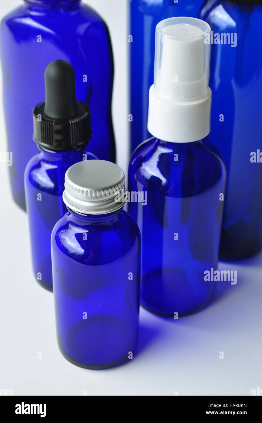 Group of dark blue cosmetic glass bottles for essential oils