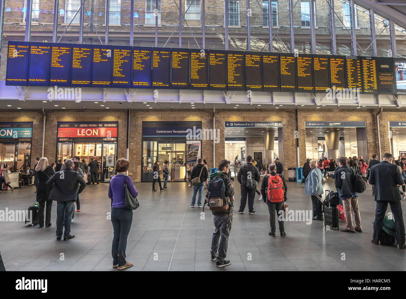 london-people-in-front-of-the-electronic-panels-with-arrival-and
