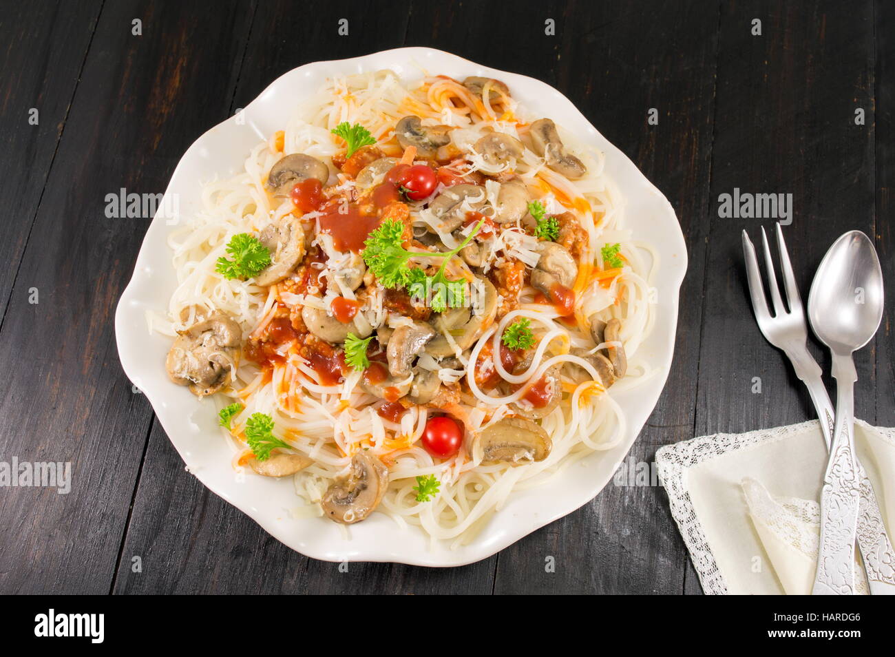 Pasta on a plate with mushrooms and cherry tomatoes Stock Photo