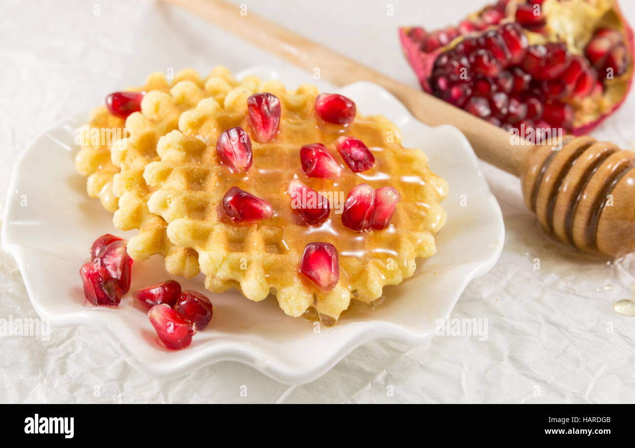 Waffle cookies with honey and pomegranate fruit Stock Photo