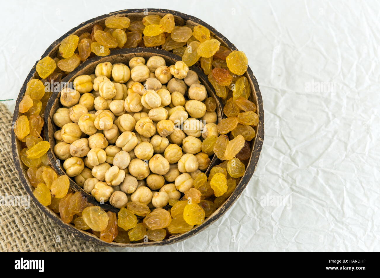 chick peas and  raisins in a big coconut shell Stock Photo