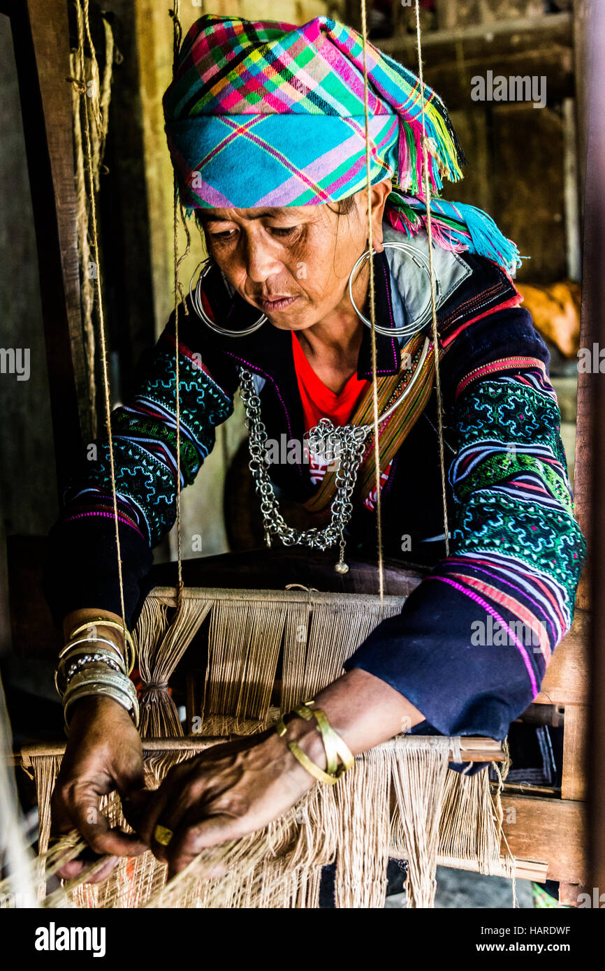 weaving old women with tribal clothes Stock Photo