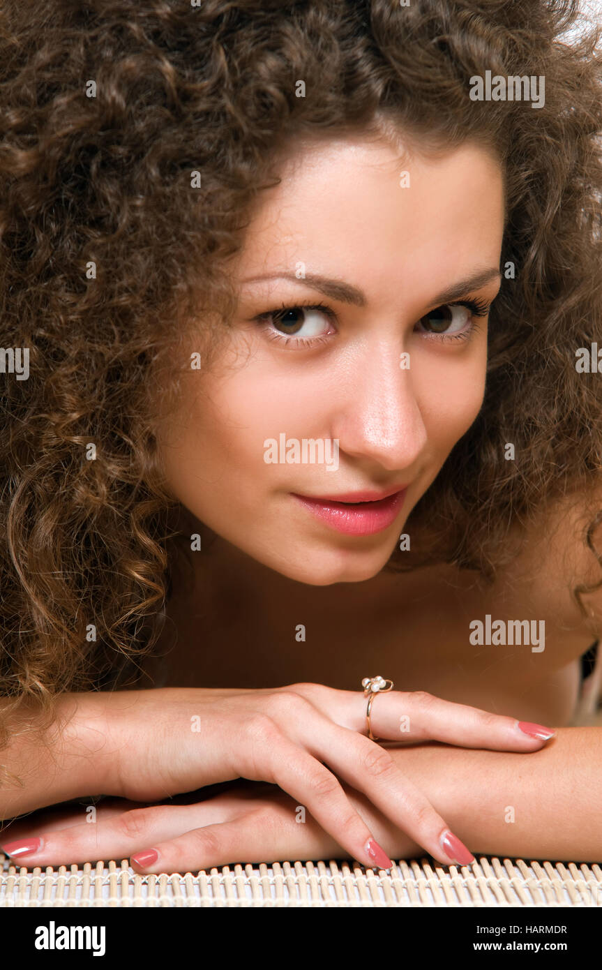 Portrait of an attractive young woman with curly hair Stock Photo - Alamy