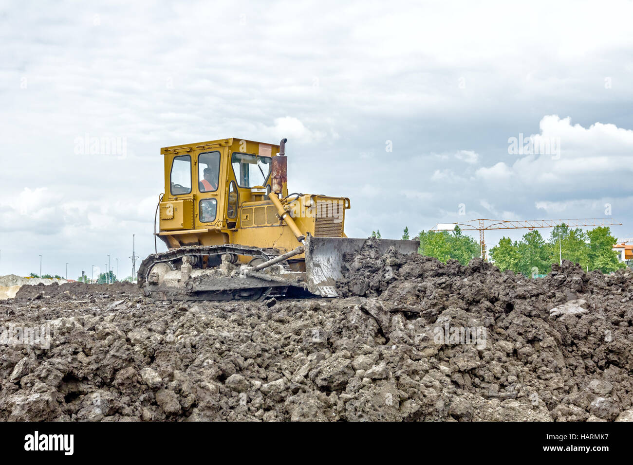 View on heavy bulldozer while he moving, leveling ground at ...