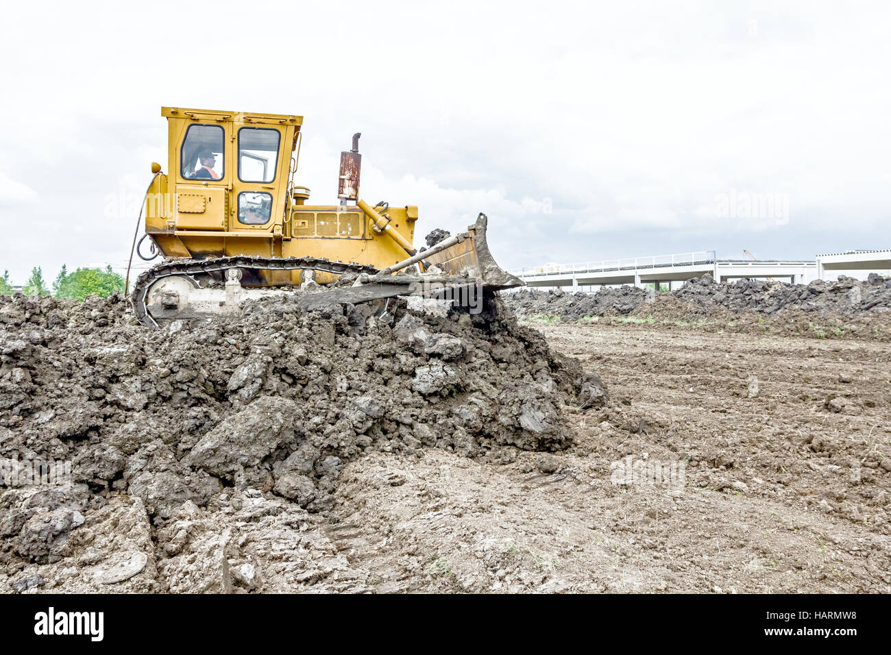 View on heavy bulldozer while he moving, leveling ground at ...