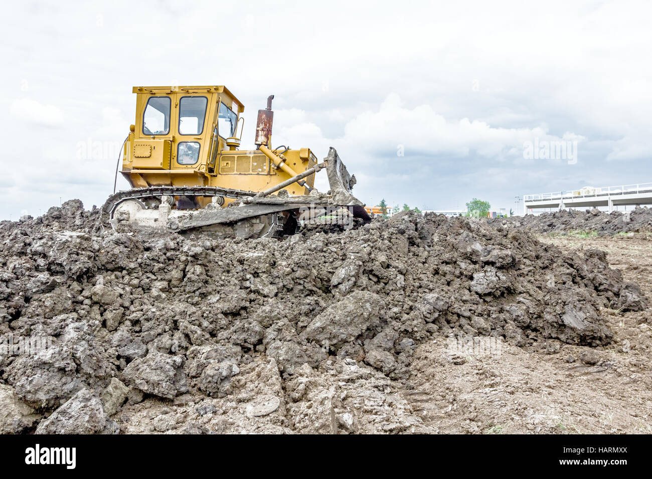 View on heavy bulldozer while he moving, leveling ground at ...