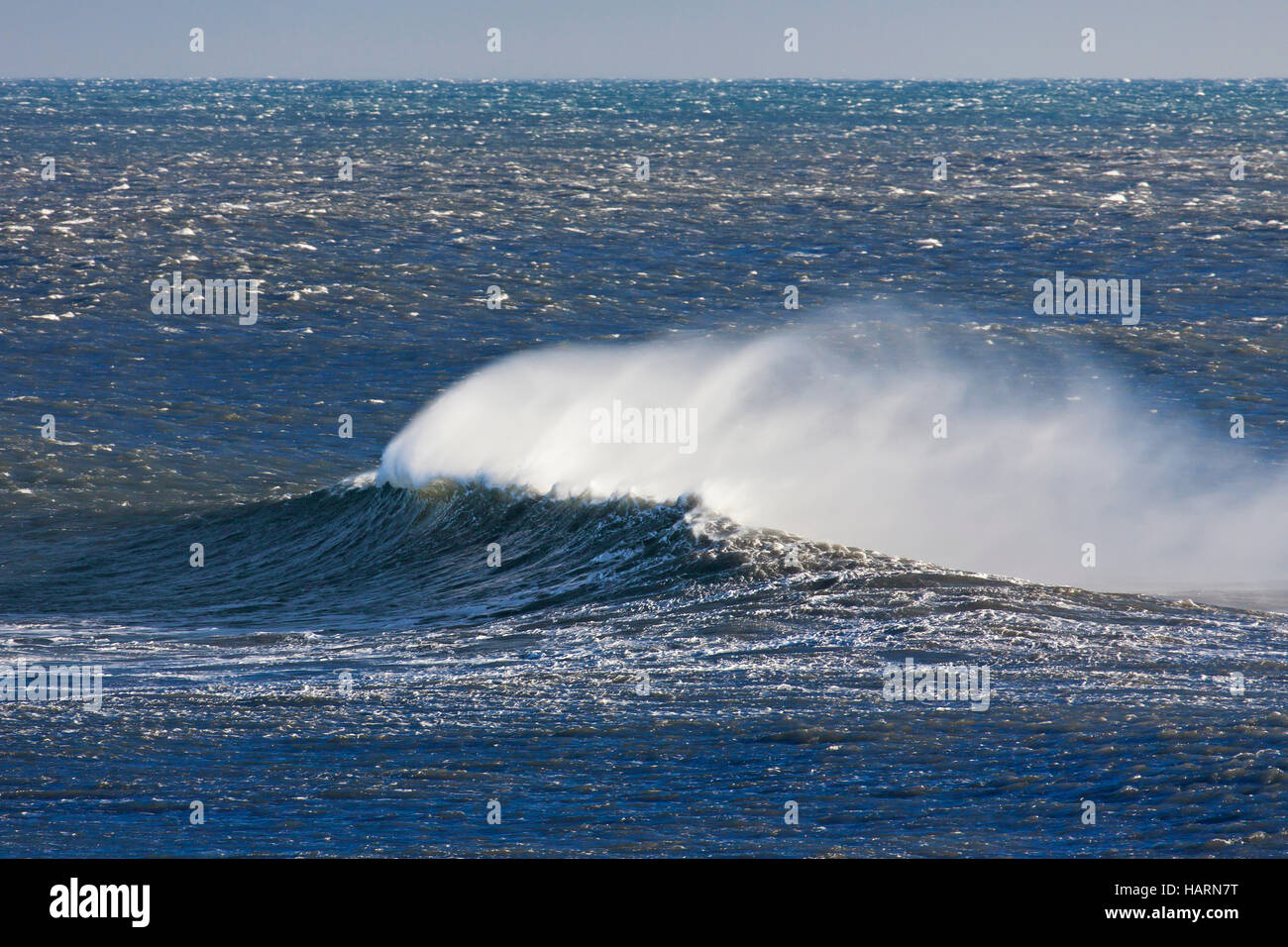 Wave crest at Arctic sea showing airborne spray and spindrift due to high winds Stock Photo