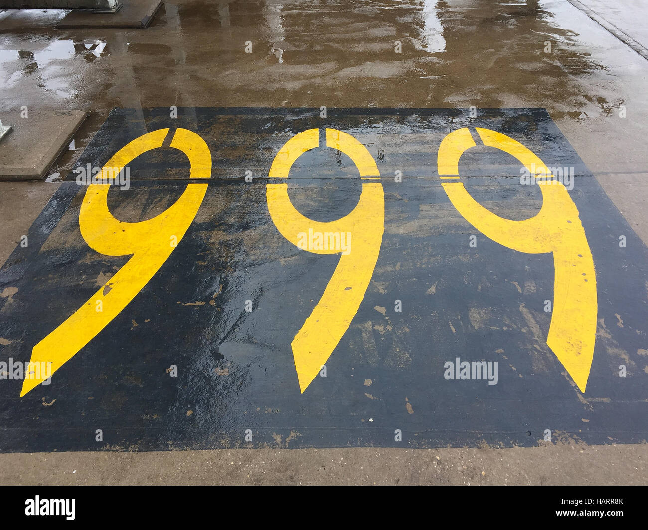 999 sign painted on the tarmac at East Midlands Airport in the airport fire and rescue service training area Stock Photo