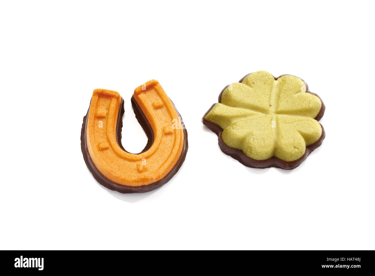 Lucky charms made of marzipan, horseshoe and clover leaf Stock Photo