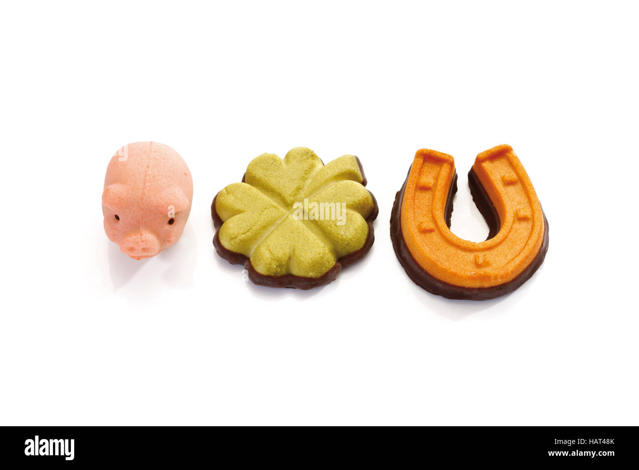 Lucky charms made of marzipan, pig, horseshoe and clover leaf Stock Photo