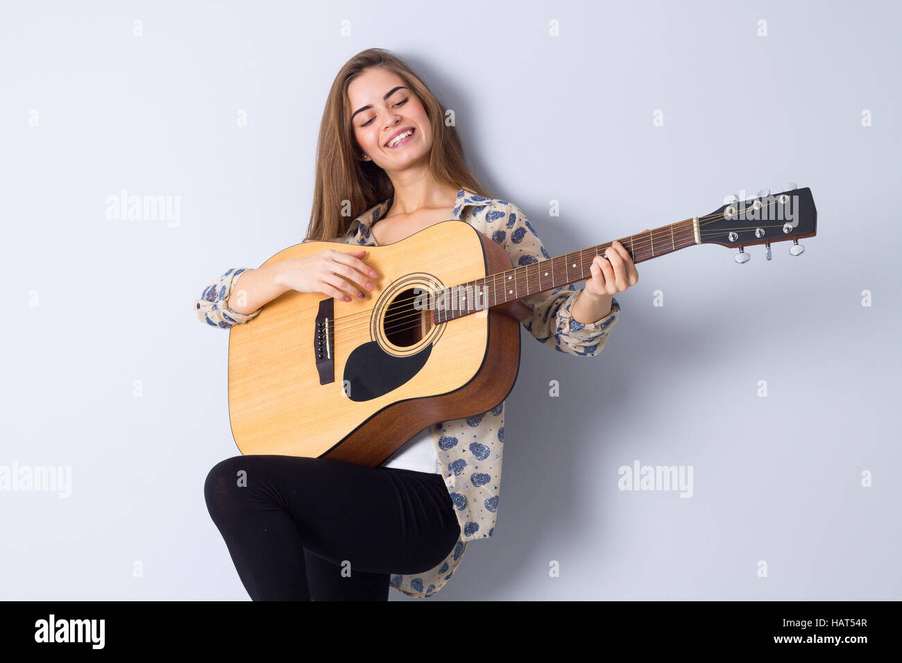 Young woman holding a guitar Stock Photo - Alamy
