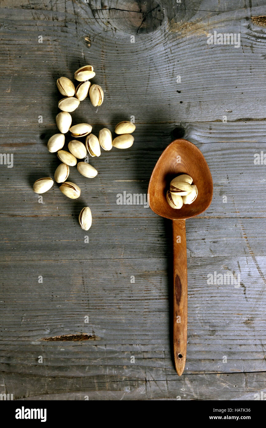Pistachios at a wooden background Stock Photo