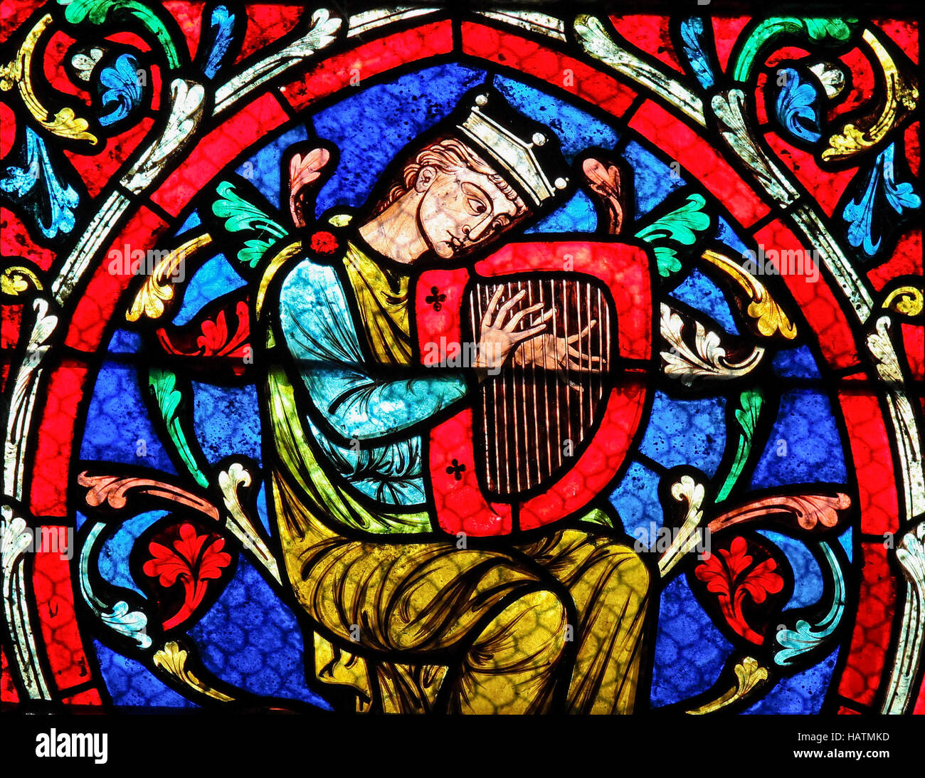 Stained glass window in the Notre Dame Cathedral in Paris, depicting King David playing on his Harp. Stock Photo