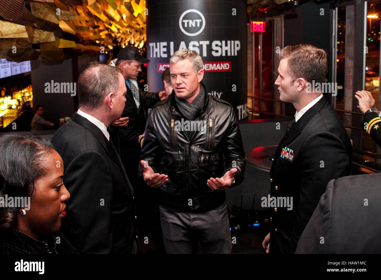 TNT TV show The Last Ship actor Eric Dane (middle) talks with U.S. Navy Office of Information East Director Corey Barker (left) during the NBA All Star game party at Clyde Frazier's Wine and Dine restaurant February 15, 2015 in New York City, New York. Stock Photo