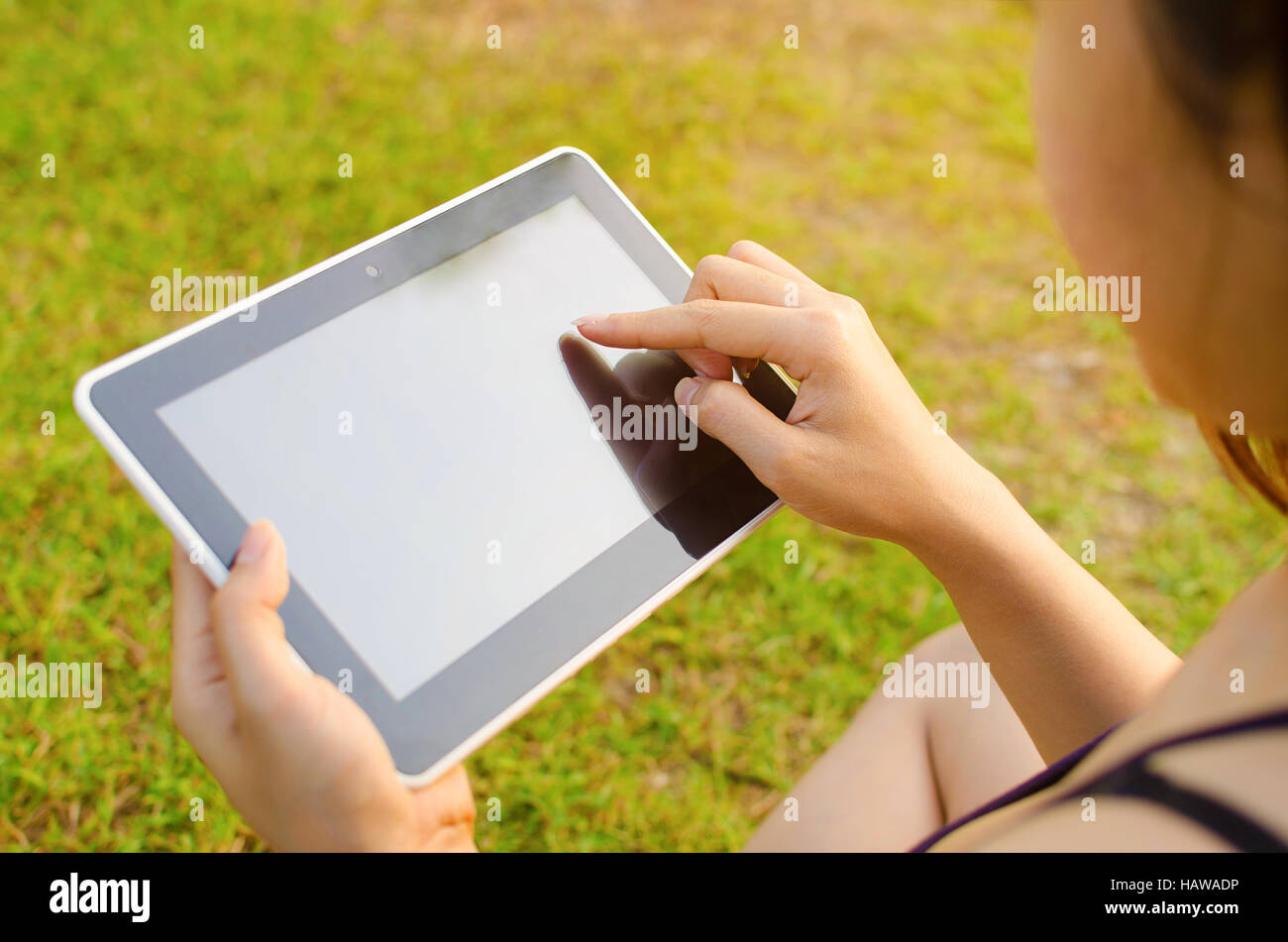Woman using digital tablet outdoors Stock Photo