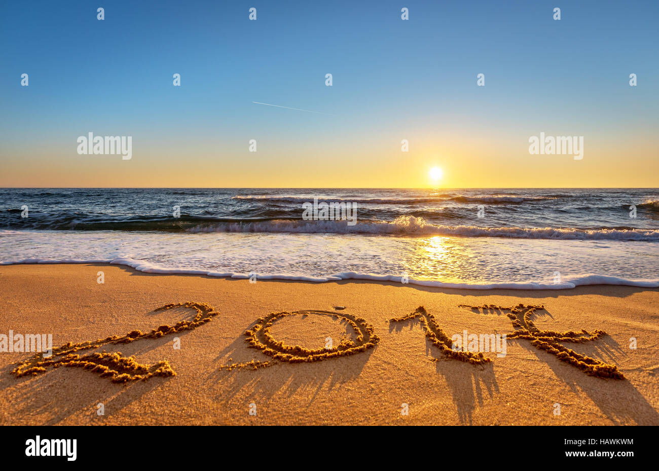 New Year 2017 is coming concept. Happy New Year 2017 replace 2016 concept on the ocean beach Stock Photo