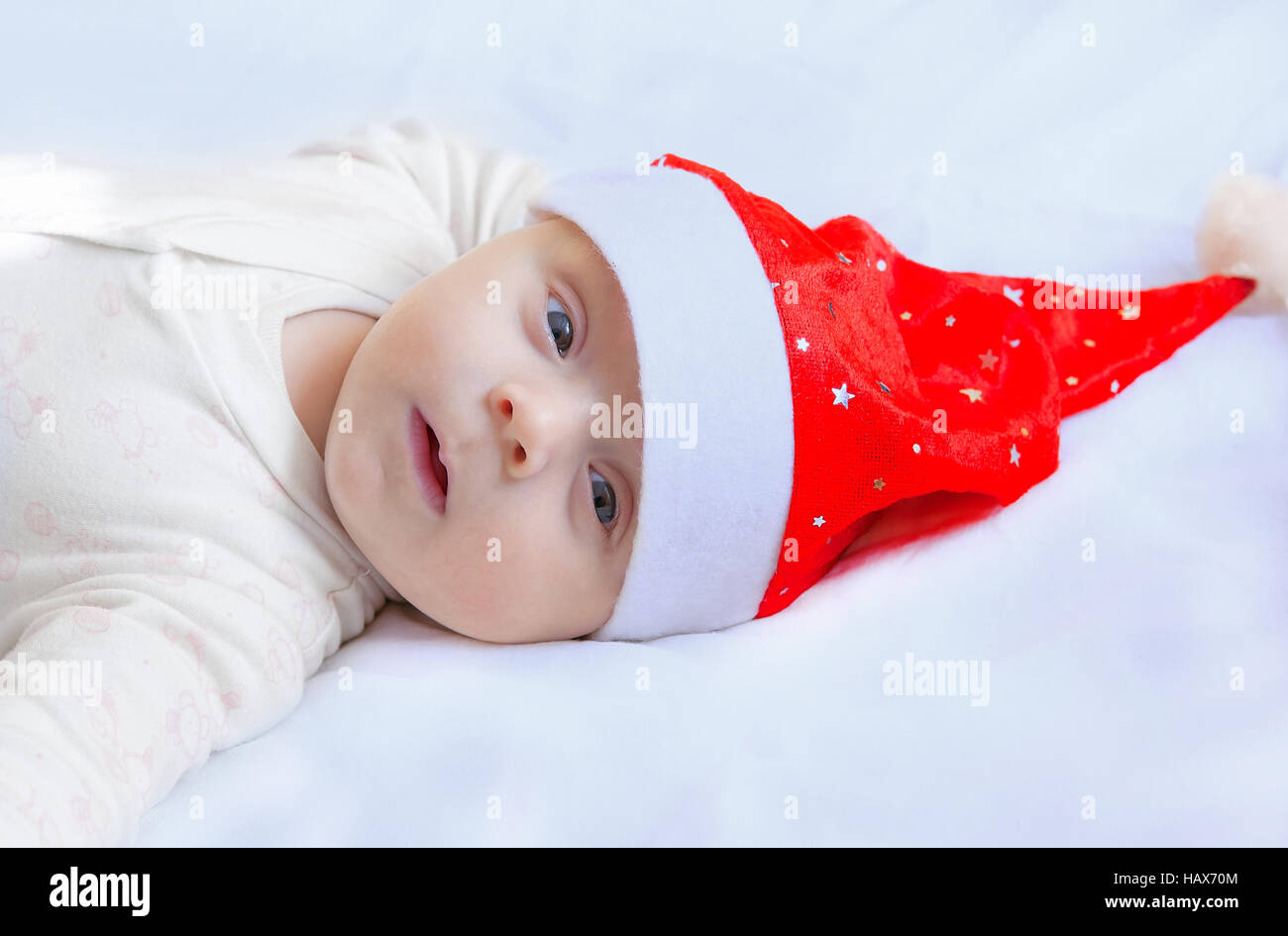 cute happy newborn baby in christmas hat Stock Photo