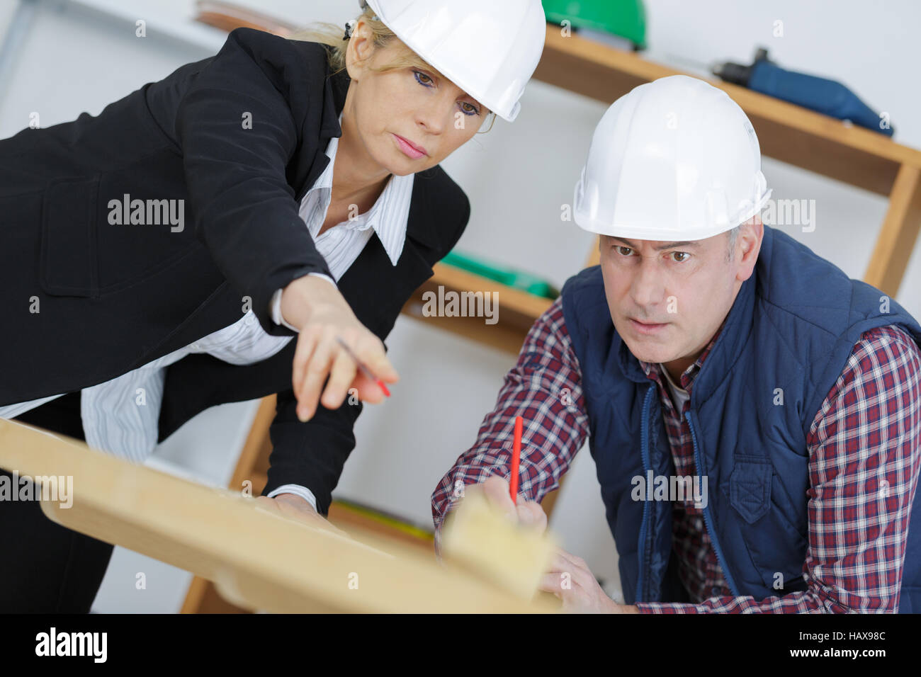 two workers standing in building Stock Photo